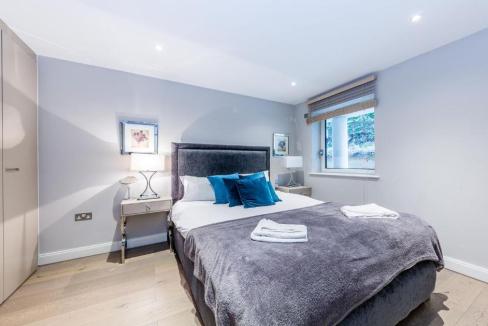 Modern bedroom with stylish decor and natural light at Westminster Regency St Apartments.