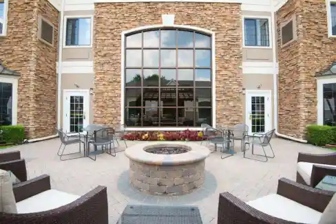 Outdoor seating area with fire pit at Columbus Airport Aparthotel.