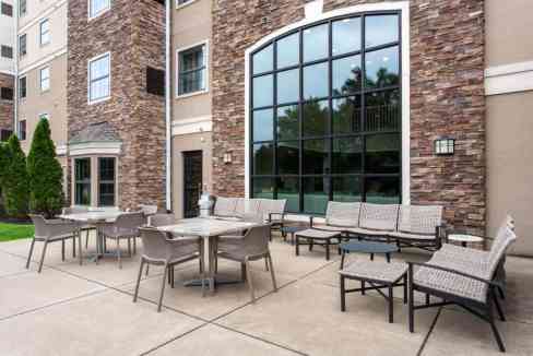 Outdoor patio area at Buffalo West Seneca Aparthotel with seating and modern design.