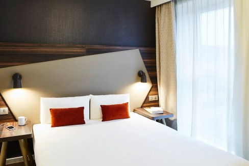 Modern hotel room at Edinburgh Canongate Aparthotel with stylish decor and natural light.
