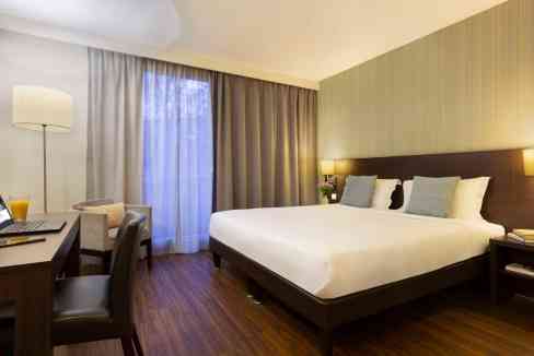 Lyon Rue Garibaldi Aparthotel room featuring a cozy bed, workspace, and contemporary decor in a cent.