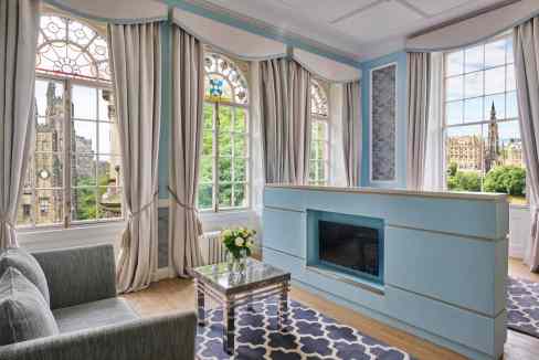 A cozy, elegant living area in Edinburgh St Giles' St Aparthotel with large windows and historic cit.