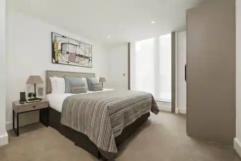Modern hotel bedroom at Chancery Lane Aparthotel, London, with stylish decor and natural light.