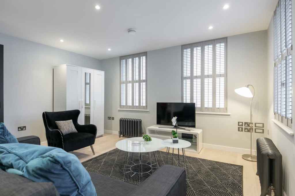 Bright and spacious living room in Covent Garden Piazza apartments with stylish furniture and large.