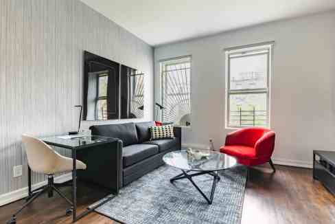 Contemporary Yorkville York Avenue Apartments living room with sleek furniture and bright windows.