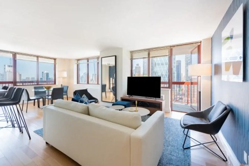 Modern Broadway Apartments living room with city views and contemporary furniture.