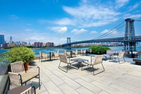 Rooftop terrace overlooking Brooklyn Bridge in South Williamsburg Brooklyn apartments. Modern outdoo.