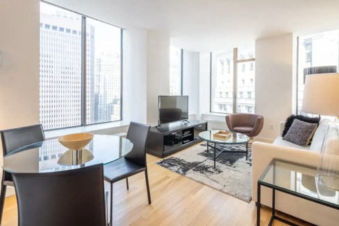 Elegant living space with city views in Wall Street apartments.