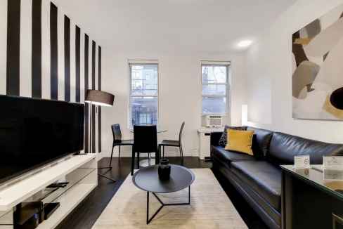 Stylish living room in Chelsea 7th Avenue Apartments with contemporary decor and natural light.