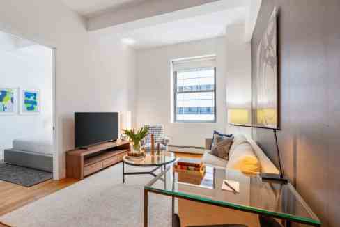 Bright living room with contemporary furniture at World Trade Center Apartments.