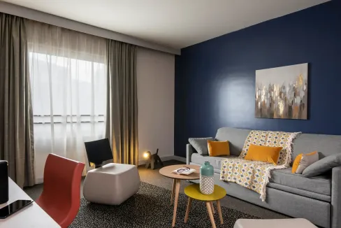 Stylish living room at Paris Esplanade de la Défense Aparthotel with modern decor and cozy seating a.