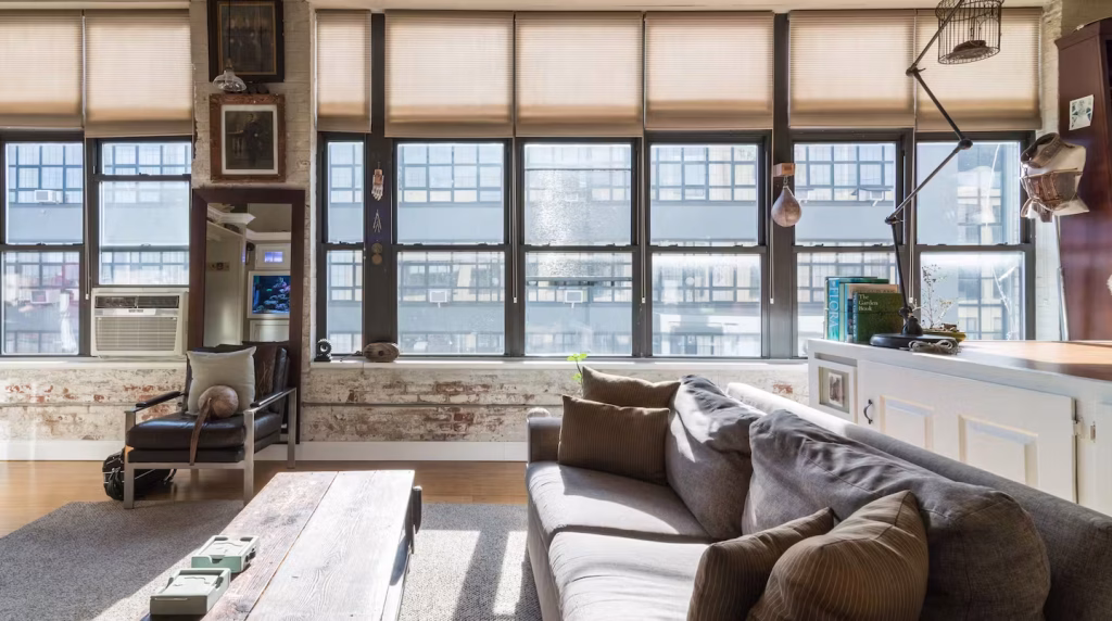 Panoramic window seating area with industrial views