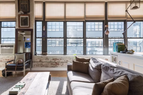 Panoramic window seating area with industrial views