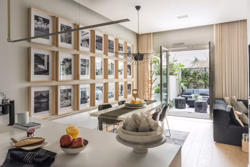 Open-plan living and dining area with gallery-style photography wall – Bastille luxury apartment