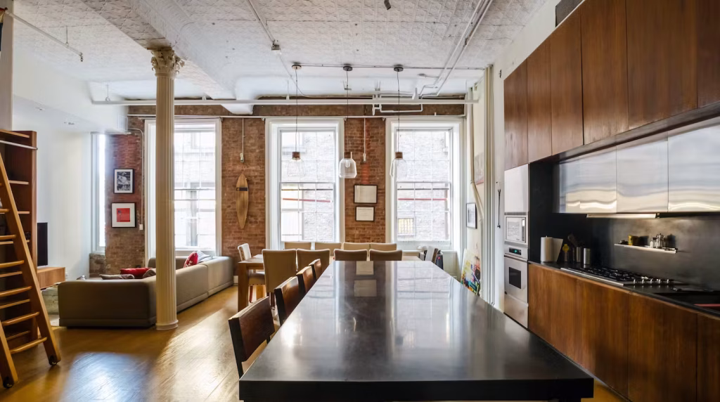 Wide view of open-plan kitchen and dining in NoHo Manhattan Apartment