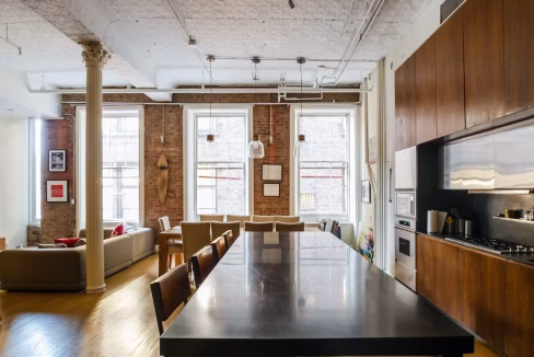 Wide view of open-plan kitchen and dining in NoHo Manhattan Apartment
