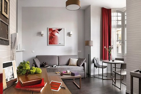 Stylish Strasbourg Aparthotel living room with contemporary decor and large windows.