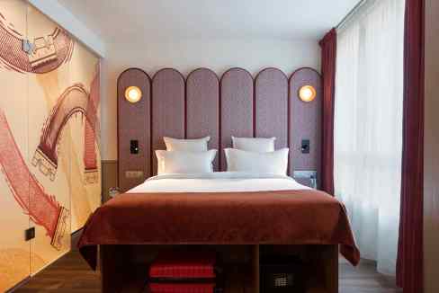 Modern bedroom at Paris Gambetta Aparthotel with stylish decor and comfortable bedding.
