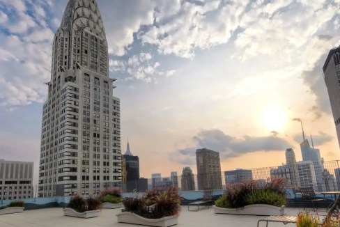 Chrysler Building with New York City skyline at sunset.