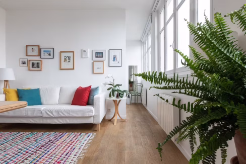 Bright living room with white walls and colourful cushions