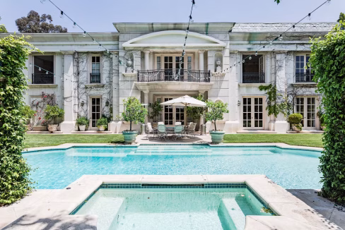 Outdoor swimming pool at Beverly Hills luxury mansion with sun loungers