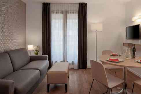 Cozy living area in Paris Rue Chaligny Aparthotel with stylish furniture and natural light.