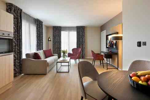 Modern Strasbourg Oberhausbergen Aparthotel living room with stylish furniture and natural light.
