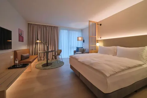 Modern hotel room at Vienna Belvedere Aparthotel with stylish decor and comfortable bedding.