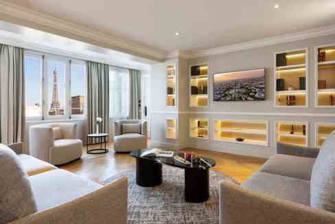 Luxurious hotel lounge featuring a view of the Eiffel Tower from large windows.