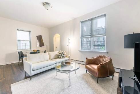 Bright and spacious living room with contemporary furniture at West Park Apartments. Perfect for rel.