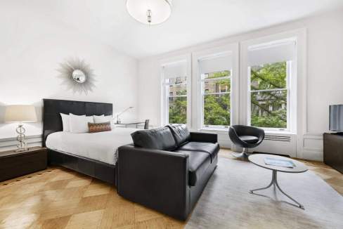 Modern Riverside Drive Apartments living room with large windows and stylish furniture.