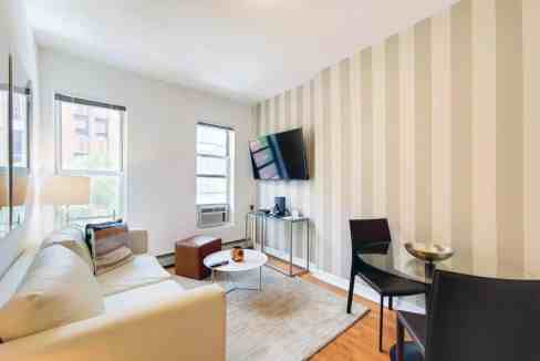 Lenox Hill serviced apartment living room with bright natural light and contemporary furnishings.