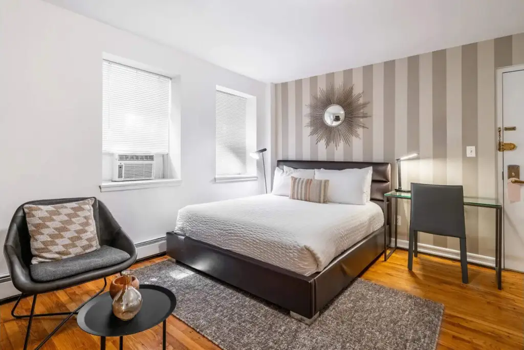 Bright bedroom with modern decor at Verdi Square Apartments.