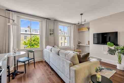 Bright living room in St John's Wood apartments with large windows and modern decor.