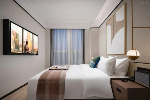 Modern hotel room with a large bed and contemporary decor in Baoding Shenzhen area.