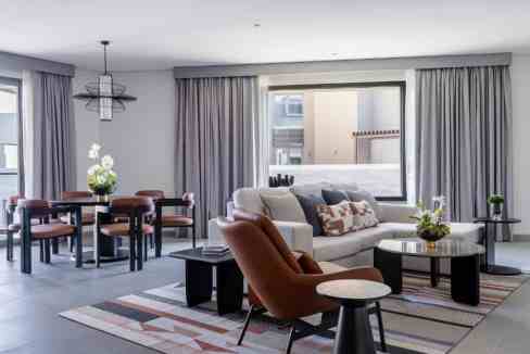 Spacious living room at Hamala Al Liwan Aparthotel with modern furniture and elegant decor.
