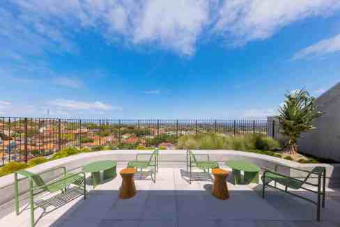 Rooftop terrace with seating and scenic city views at Sydney Bondi Junction Aparthotel.