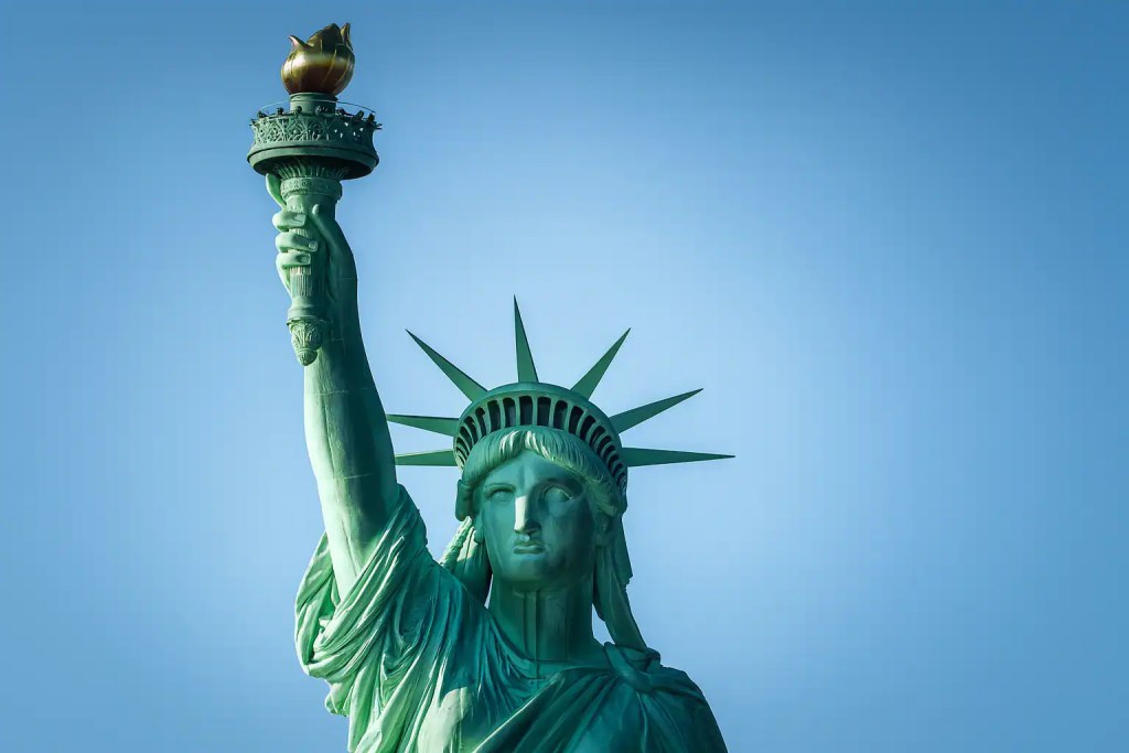 Statue of Liberty with torch raised, symbol of freedom and New York City landmark.