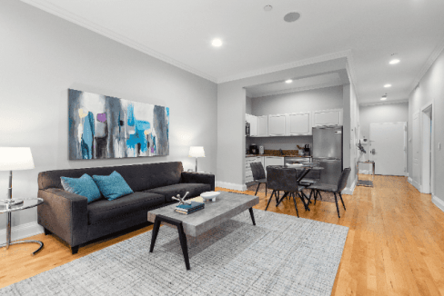 Bright living room in NYC Madison Apartments with contemporary decor and hardwood floors.