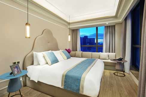 Modern hotel room with a large bed and city views in Beijing.