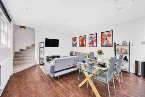 Bright and spacious living room with contemporary decor at Limehouse Lowell St Apartments. Perfect f.