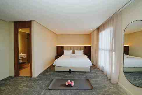 Aptly styled bedroom at Casablanca Almaz Aparthotel featuring a comfortable bed and elegant design.