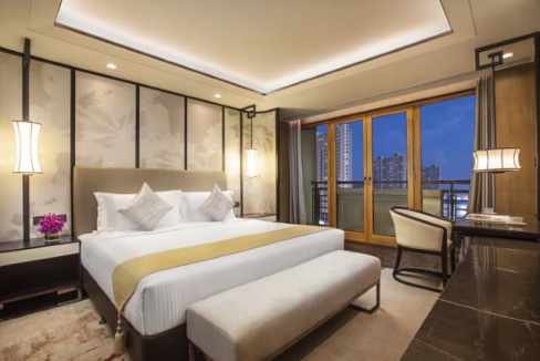 Luxury hotel room with modern decor and city views at Beijing Xiaotaihou River Aparthotel.