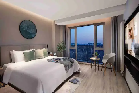 Aparthotel room in Beijing Daxing District featuring a large window with cityscape view and contempo.