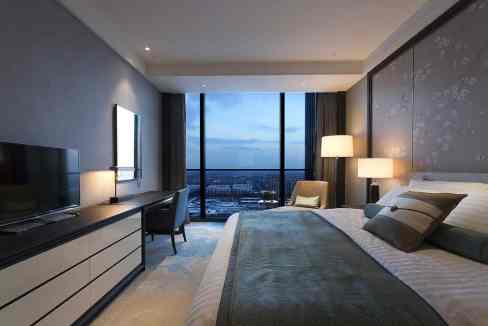 Beijing Damei Plaza Aparthotel room with large window and city skyline view.