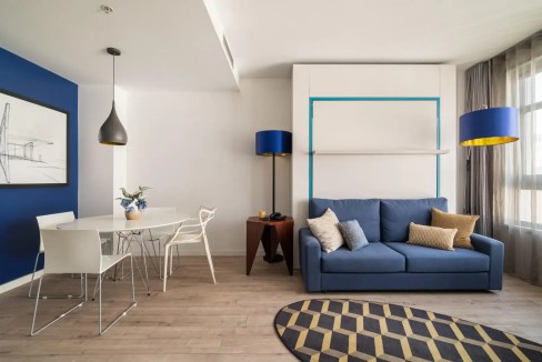 Elegant hotel suite in Barcelona with contemporary design and cozy seating area.