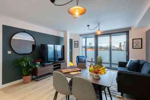 Modern Manchester Market Street Apartments living room with stylish furniture and city views.