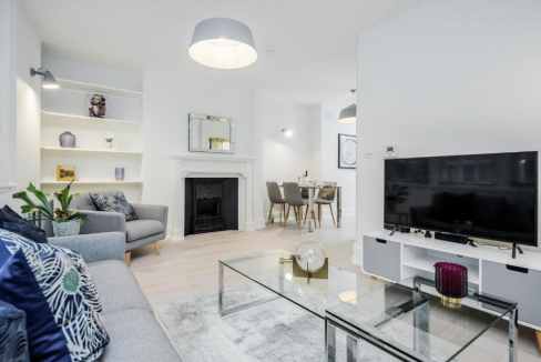 Stylish living room at Covent Garden Brydges Apartments with modern decor and comfortable seating.