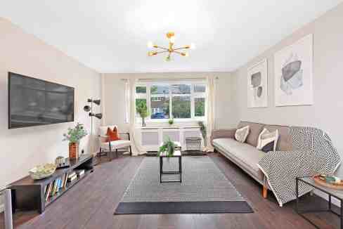 Bright living room with large window and contemporary decor.
