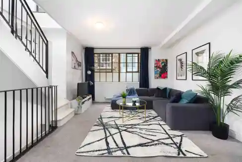Bright and stylish living room in Hoxton Fullwood's Mews Apartments, featuring contemporary decor an.